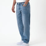 The Jeans Relaxed Straight Fit in light midwash — worn with white sneakers