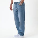 The Jeans Relaxed Straight Fit in light midwash — worn with white sneakers