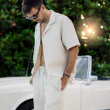 Le Waffle Resort Shirt in light beige — worn as a matching set next to a classic white car