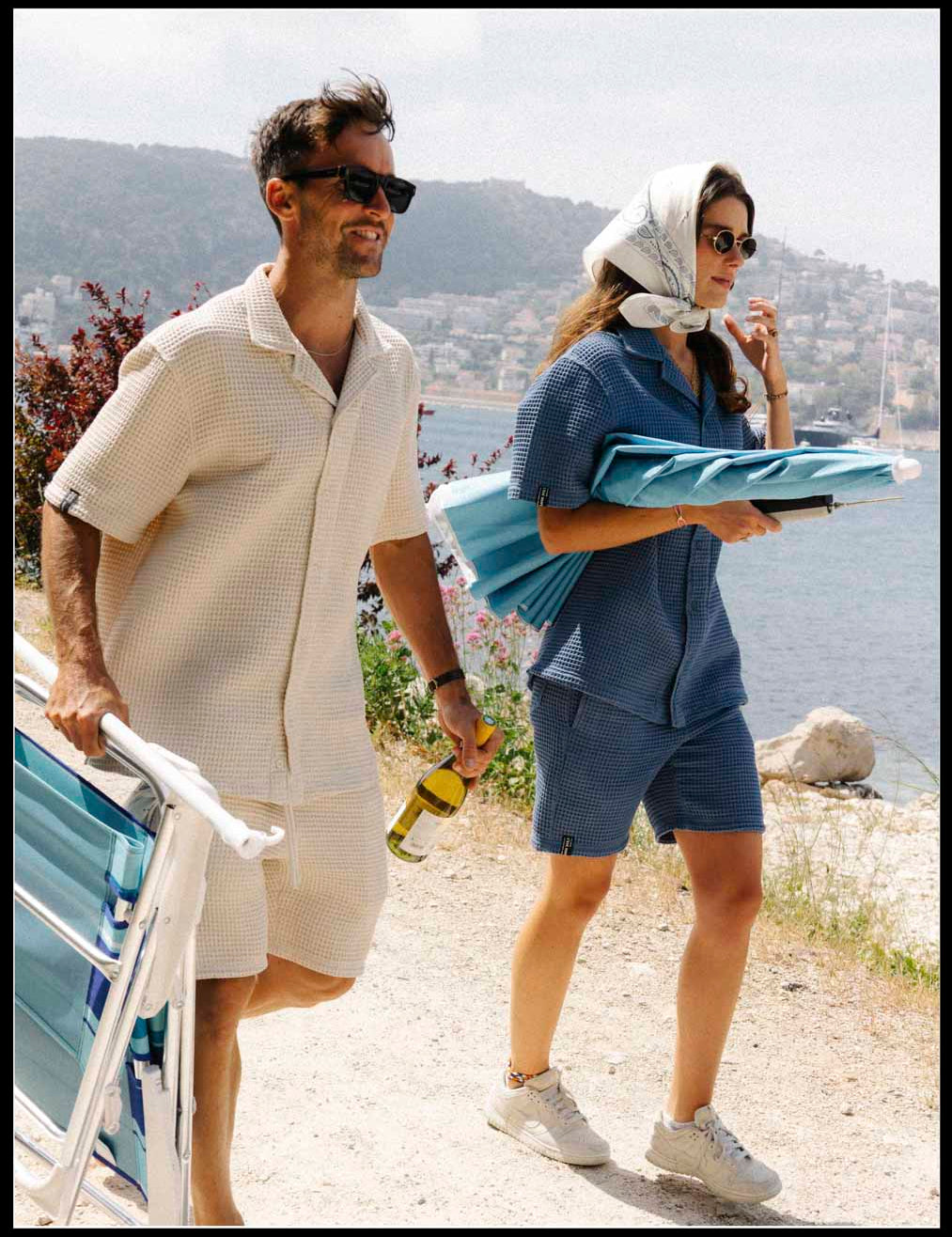 Le Waffle Resort Shirt in light beige — worn while carrying beach chairs on a sunny coastal path