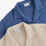 Le Waffle Resort Shirt in azure — close-up showing the waffle-woven texture and neck labels.