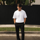 The Proper Pant Relaxed Straight Fit in black — worn with a white t-shirt and sneakers