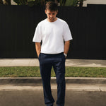 The Proper Pant Relaxed Straight Fit in navy — worn with a white t-shirt and black sneakers