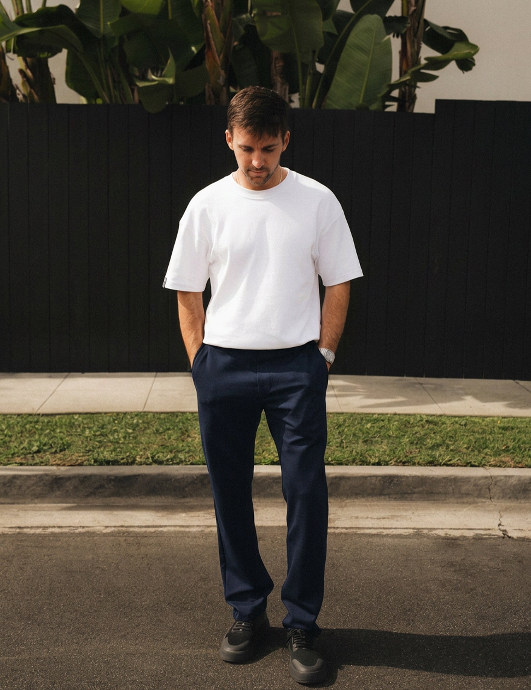 The Proper Pant Relaxed Straight Fit in navy — worn with a white t-shirt and black sneakers