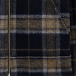 The Reversible Wool Jacket in plaid — close-up of zipper and pattern