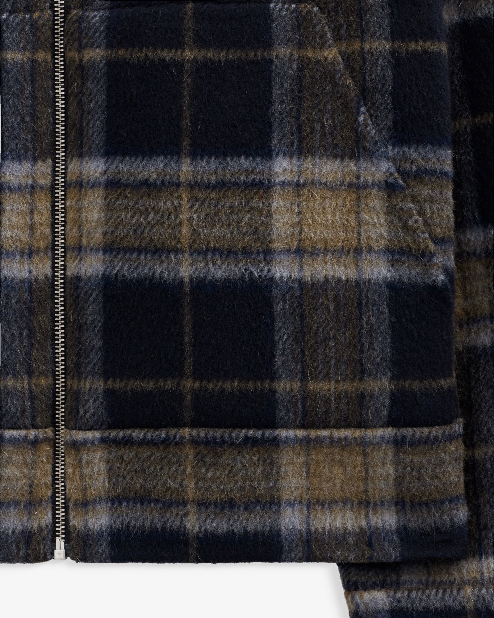 The Reversible Wool Jacket in plaid — close-up of zipper and pattern