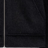 The Reversable Wool Jacket in black — close-up of the zipper and wool texture