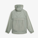 A back view of The Running Jacket in sage green, laid flat on a white background. The image highlights the hood, a back ventilation panel with reflective ATHLÉTIQUE text, and the c'est normal logo at the bottom hem.