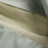 A detailed close-up of The Running Jacket in Sage Green, focusing on the interior mesh lining and back ventilation panel designed to dump heat.