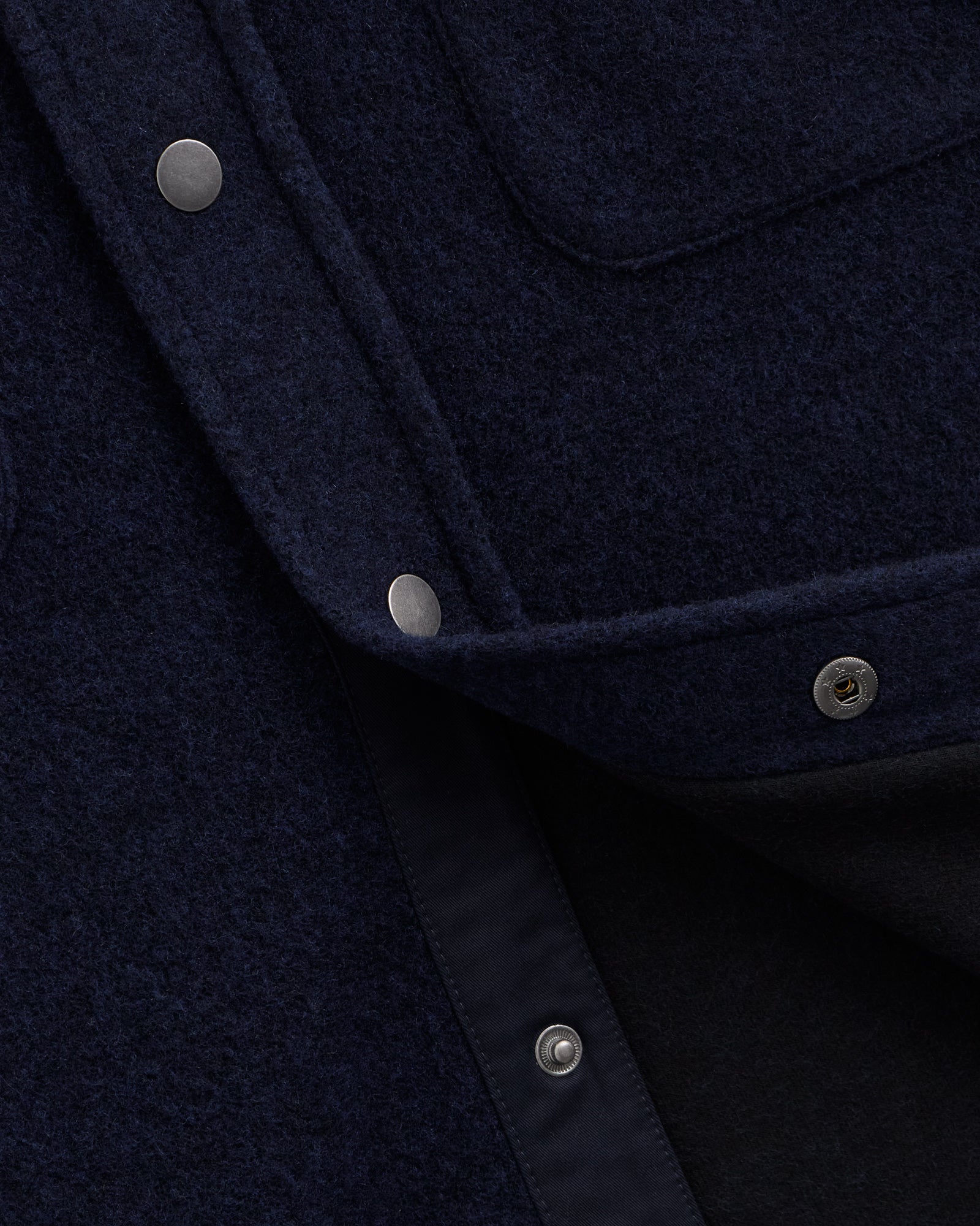 Stockholm Wool Shacket in blue — close-up of the metal snap buttons and wool texture