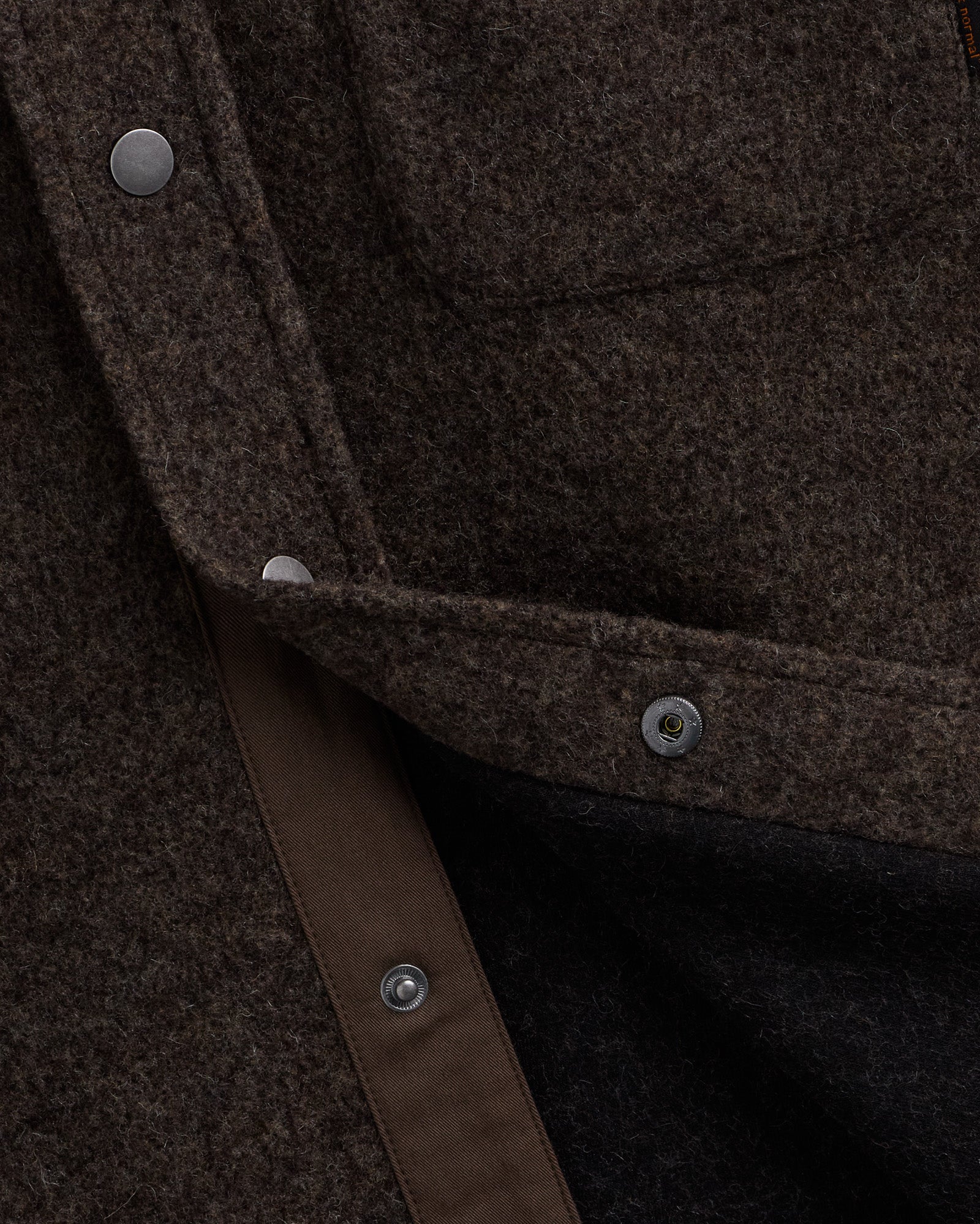 Stockholm Wool Shacket in brown melange — close-up of the snap buttons and wool texture