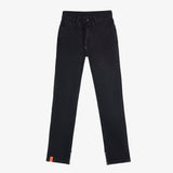 A front view of The Jeans Regular Fit in black, laid flat on a white background. The image highlights the drawstring waist, five-pocket design, ankle zippers, and the orange c'est normal label at the ankle.