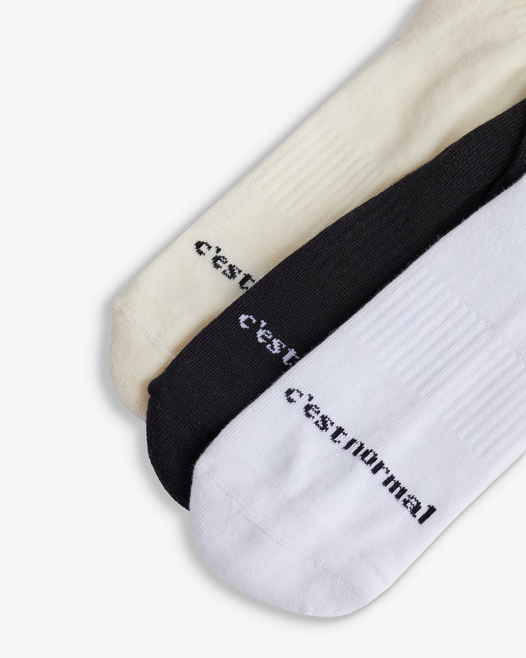 The Sock in black, white and ecru — C'est normal logo branding on the toes