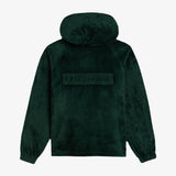 The Oversized Teddy Hoodie in pine — back view showing the embossed C'est normal logo