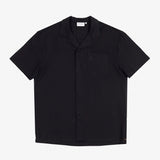 The Linen Resort Shirt in black — flat lay front view with a camp collar and chest pocket