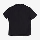 The Linen Resort Shirt in black — back view showing the logo embroidered on the yoke