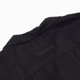 The Linen Resort Shirt in black — back yoke with tonal C'est normal embroidery