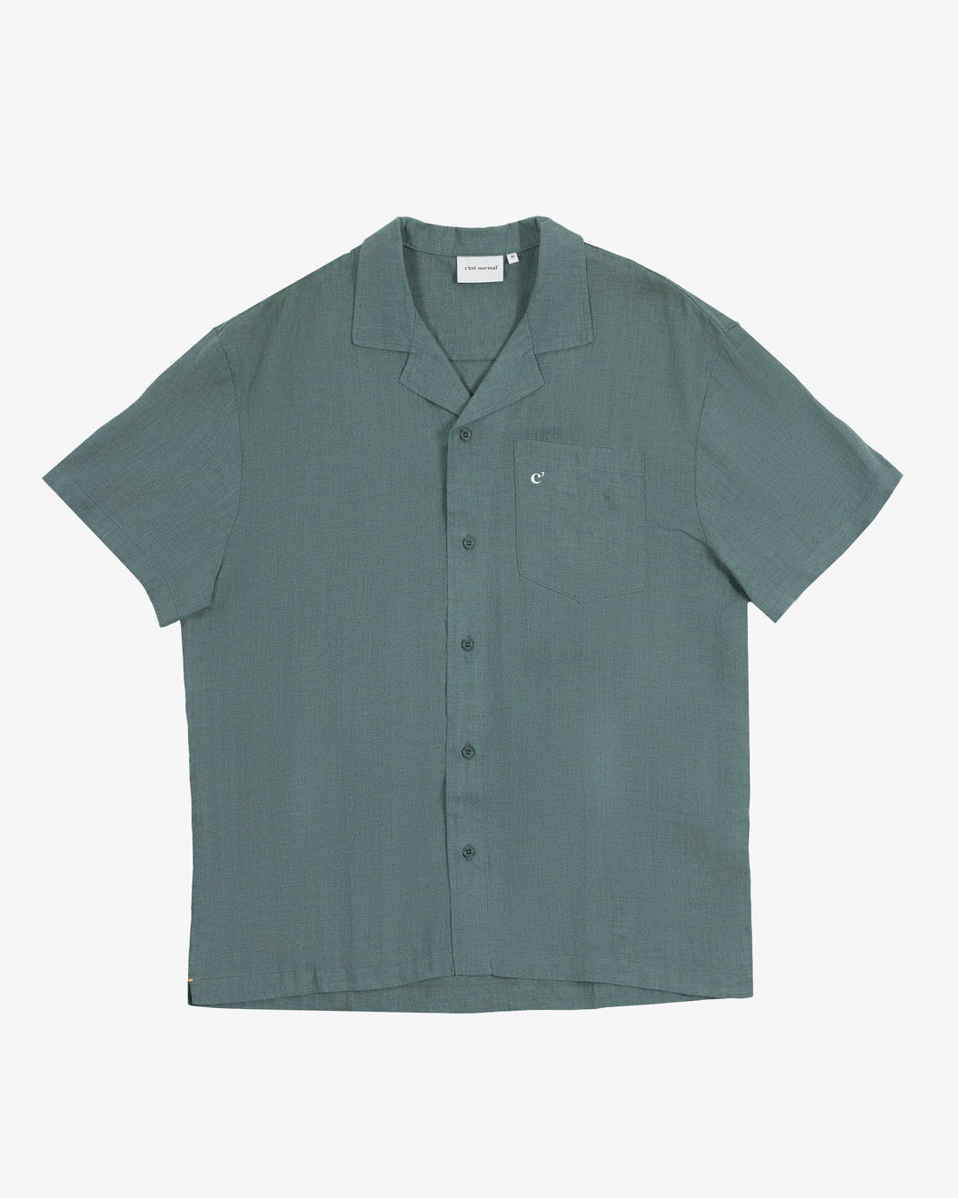 The Linen Resort Shirt in sage — flat lay with camp collar and chest pocket