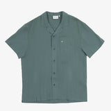 The Linen Resort Shirt in sage — flat lay with camp collar and chest pocket