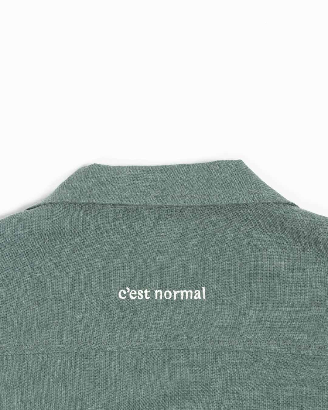 The Linen Resort Shirt in sage — white C'est normal embroidery on the back yoke