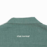 The Linen Resort Shirt in sage — white C'est normal embroidery on the back yoke