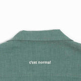 The Linen Resort Shirt in sage — white C'est normal embroidery on the back yoke