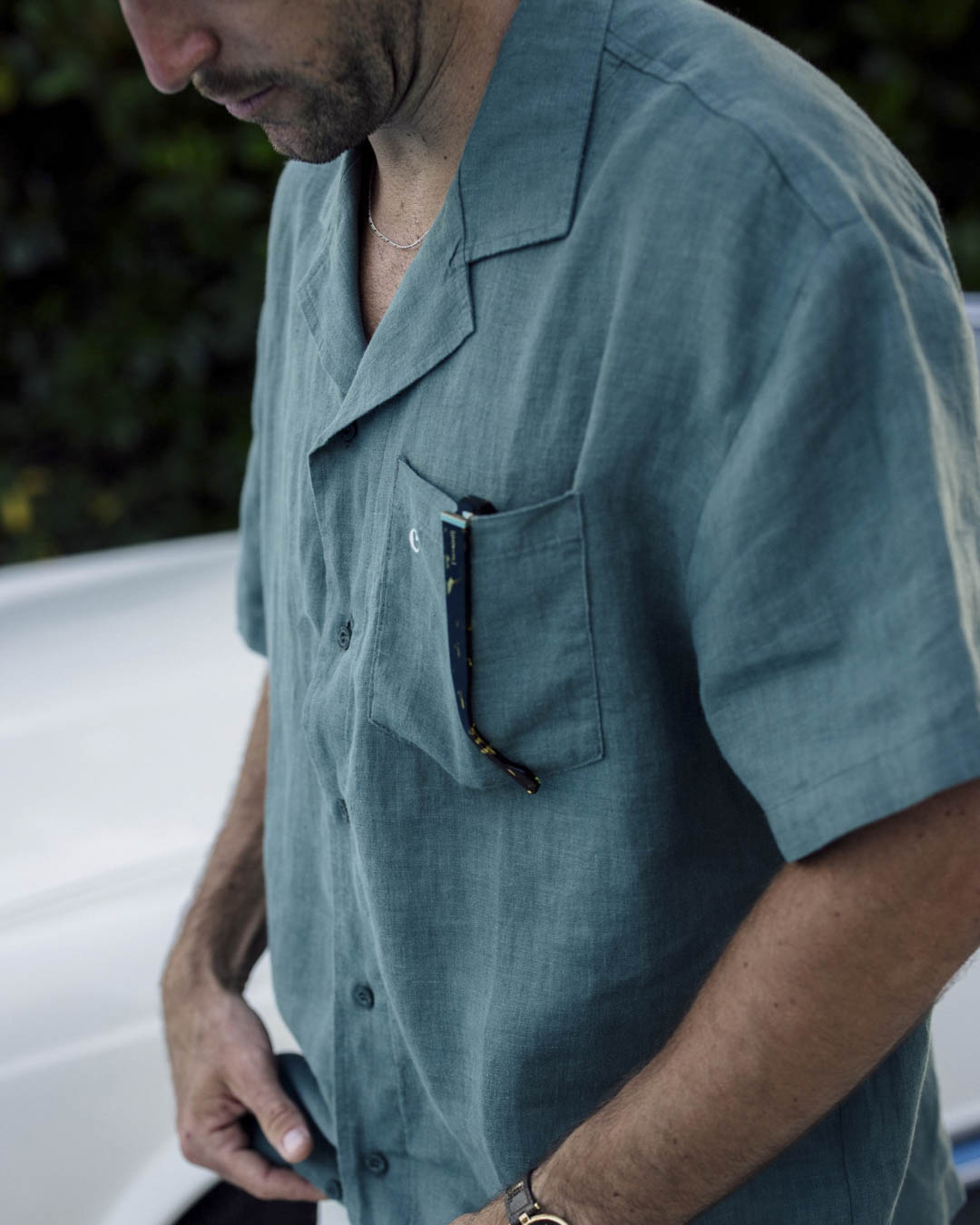 The Linen Resort Shirt in sage — sunglasses in the chest pocket