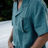 The Linen Resort Shirt in sage — sunglasses in the chest pocket