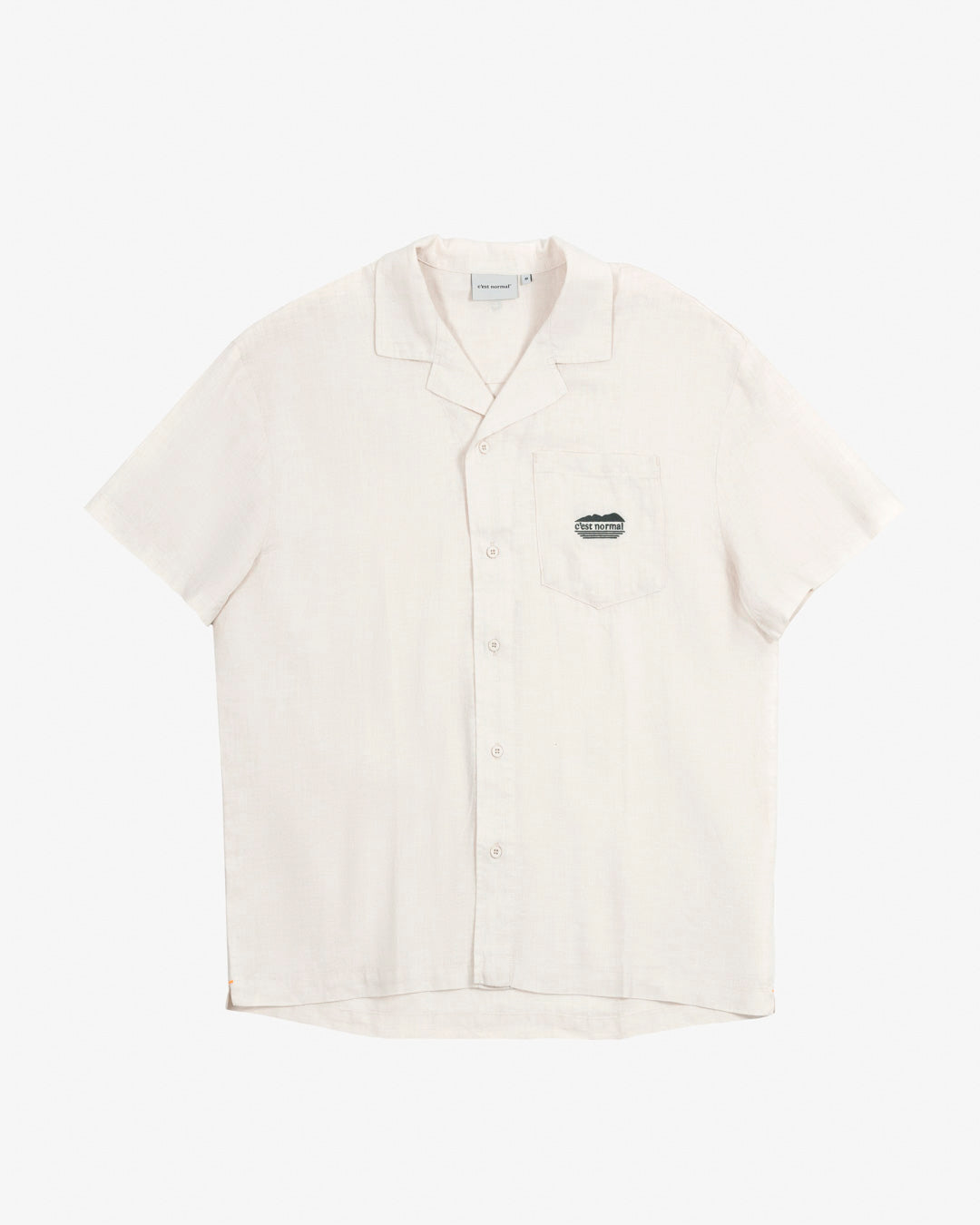 The Tampah Hills Linen Resort Shirt in cream — flat lay view with embroidered chest pocket