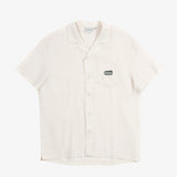 The Tampah Hills Linen Resort Shirt in cream — flat lay view with embroidered chest pocket