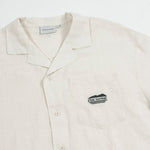 The Tampah Hills Linen Resort Shirt in cream — C'est normal logo on the chest pocket
