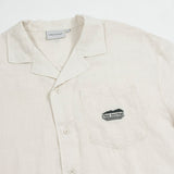 The Tampah Hills Linen Resort Shirt in cream — C'est normal logo on the chest pocket