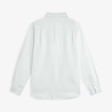 The Daily Linen Shirt in off-white — back view showing the yoke and pleats