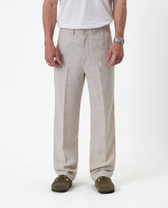 The Daily Linen Trouser in natural — front view showing the straight leg and pressed crease