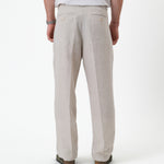 The Daily Linen Trouser in natural — back view with functional welt pockets