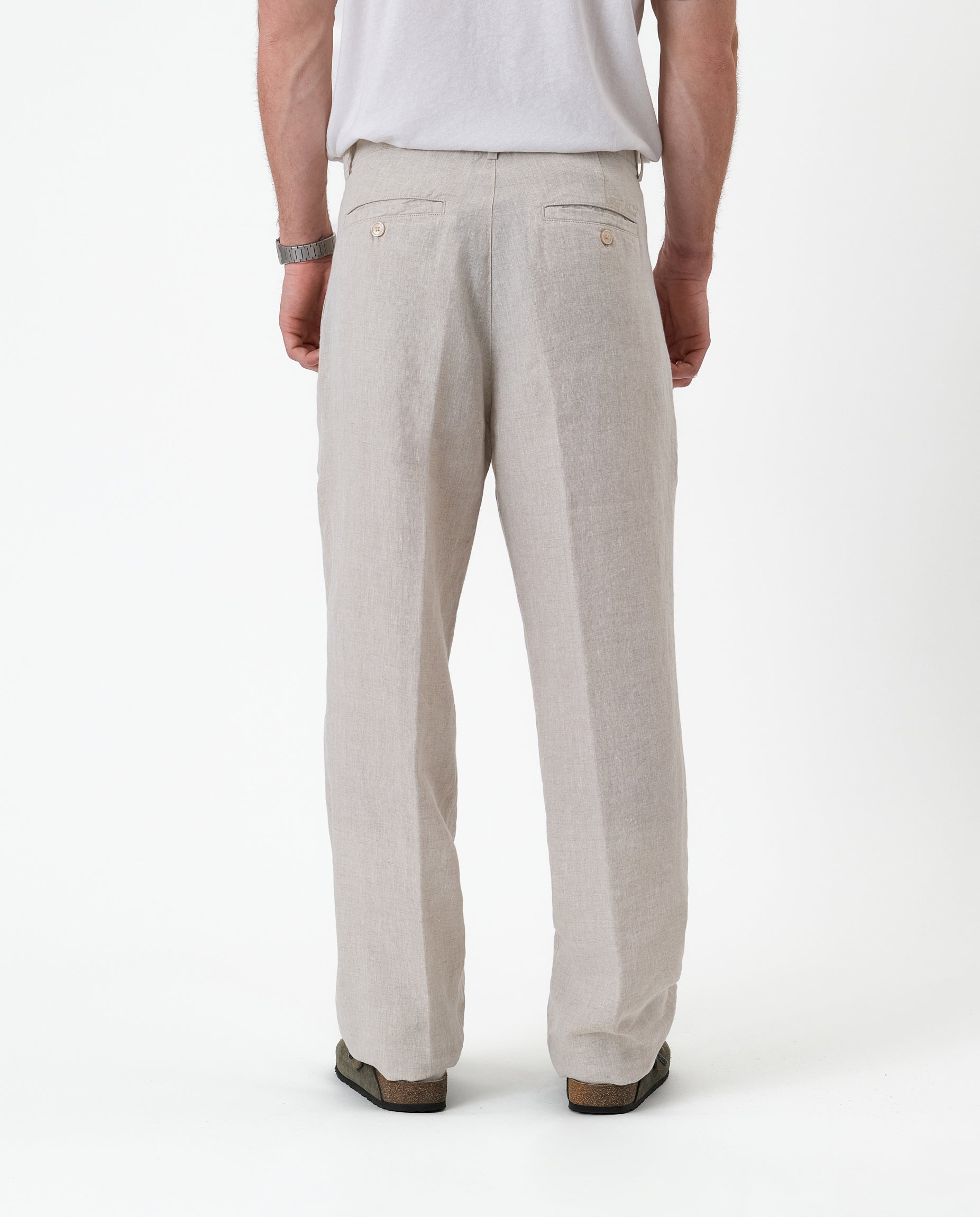 The Daily Linen Trouser in natural — back view with functional welt pockets