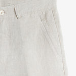 The Daily Linen Trouser in natural — close-up of the slanted front pocket and button
