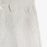 The Daily Linen Trouser in natural — close-up of the slanted front pocket and button