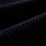 The Denim Jacket in rinse blue — close-up of the stretch motion denim fabric