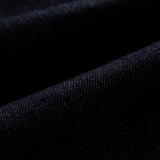 The Denim Jacket in rinse blue — close-up of the stretch motion denim fabric