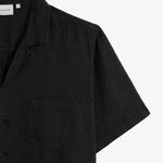 The Holiday Linen SS Shirt in black — close-up of the collar and chest pocket