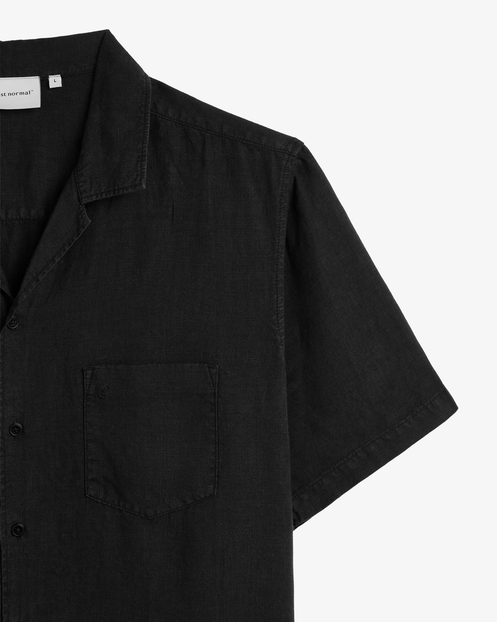 The Holiday Linen SS Shirt in black — close-up of the collar and chest pocket