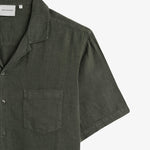 The Holiday Linen SS Shirt in Dark Khaki — close-up of the chest pocket and collar