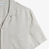 The Holiday Linen SS Shirt in natural — close-up of the chest pocket and linen texture