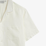The Holiday Linen SS Shirt in off white — close-up of the collar and chest pocket detail