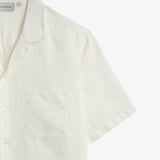 The Holiday Linen SS Shirt in off white — close-up of the collar and chest pocket detail