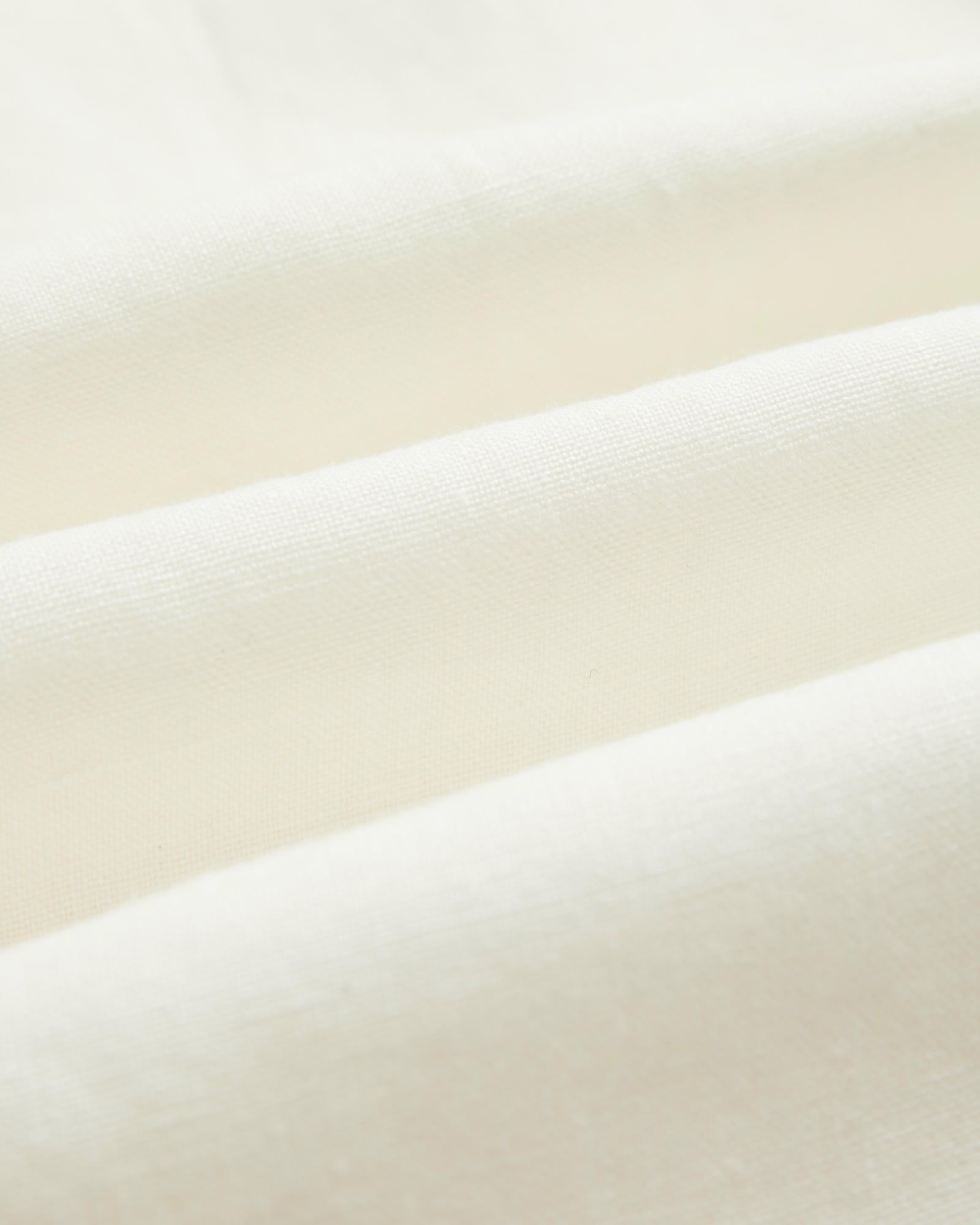The Holiday Linen SS Shirt in off white — close-up of the breathable linen fabric texture