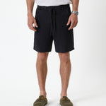 The Holiday Linen Short in black — front view against a white background