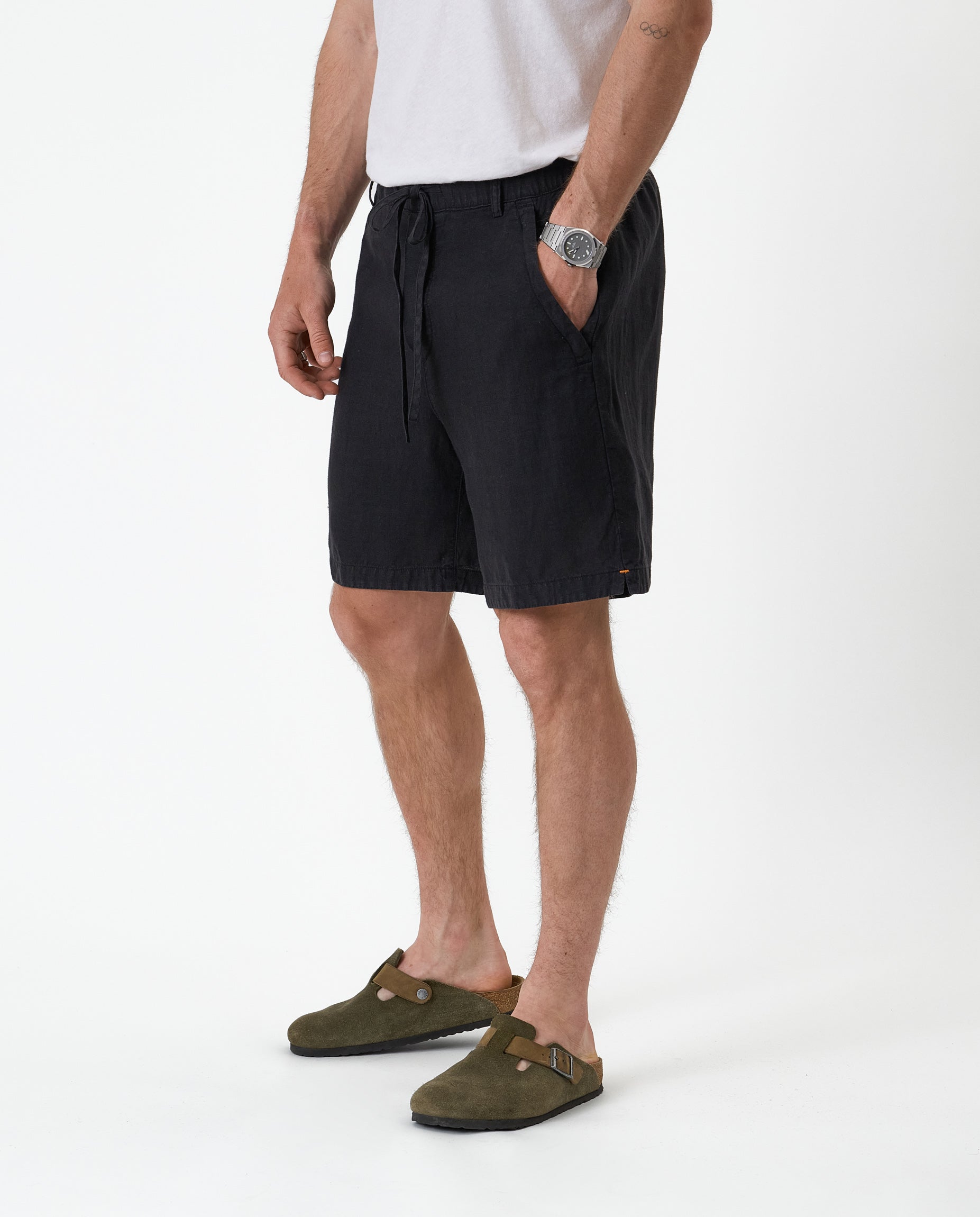 The Holiday Linen Short in black — side view showing the drawstring waist and side pockets