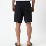 The Holiday Linen Short in black — back view showing the elasticated waistband and pocket